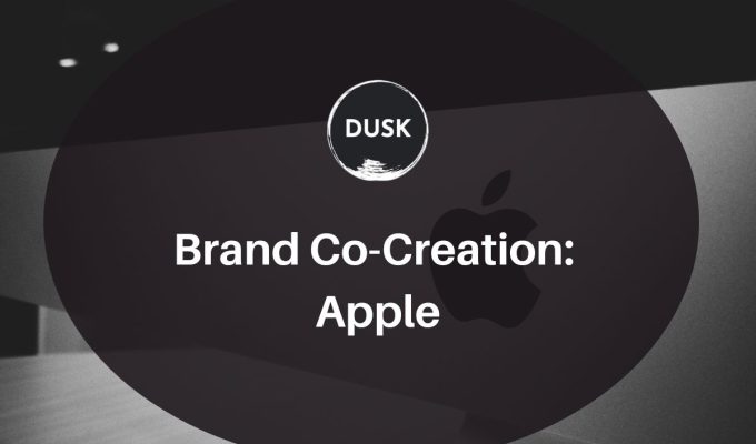 Front image of a blog titled " Brand Co-Creation: Apple "with ppc infographic photo illustration as the background and the title displayed in corporate typography